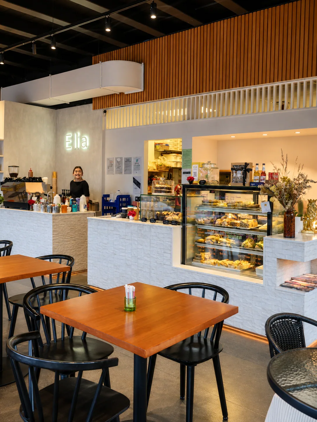 The bright Cafe Elia interior with its counter, cabinet food and timber tables