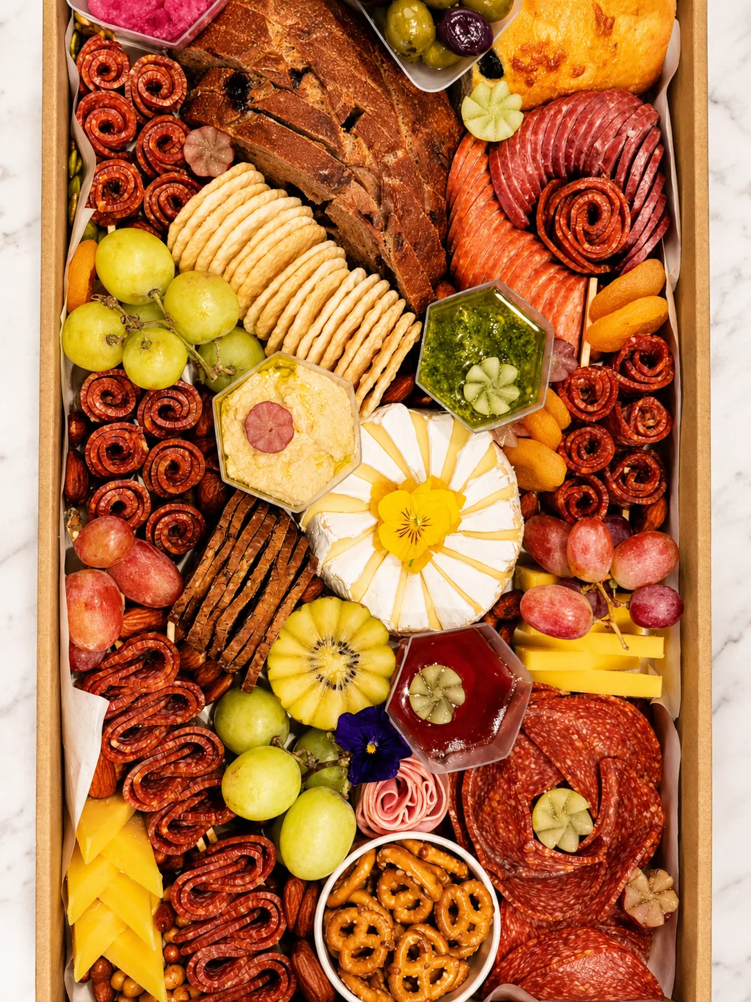 A Cafe Elia sharing platter with cheese, fruit, crackers and savoury bites