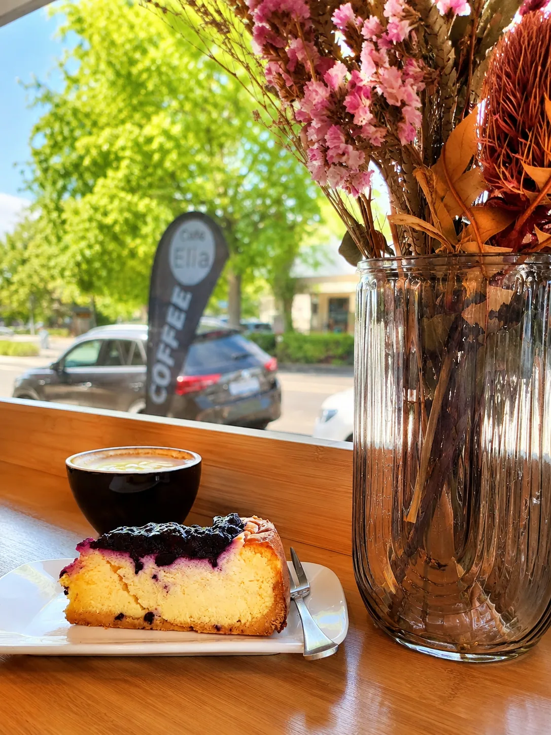 Coffee and blueberry cake by the Cafe Elia window