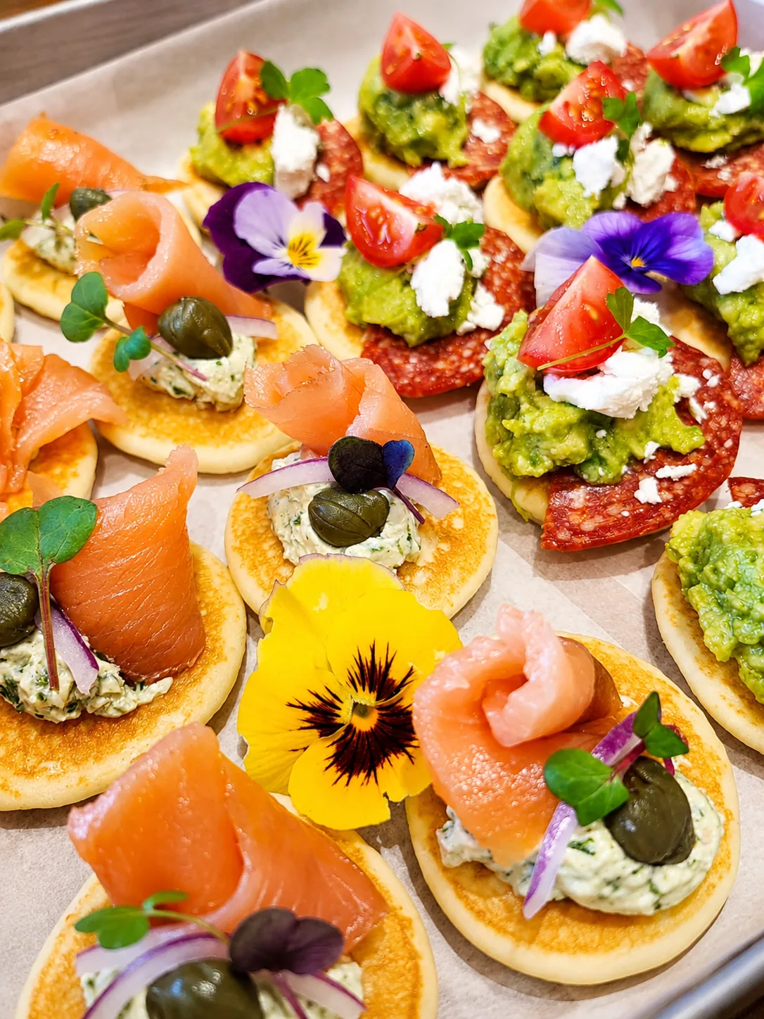 Freshly prepared Cafe Elia savoury pancakes with salmon, avocado and edible flowers